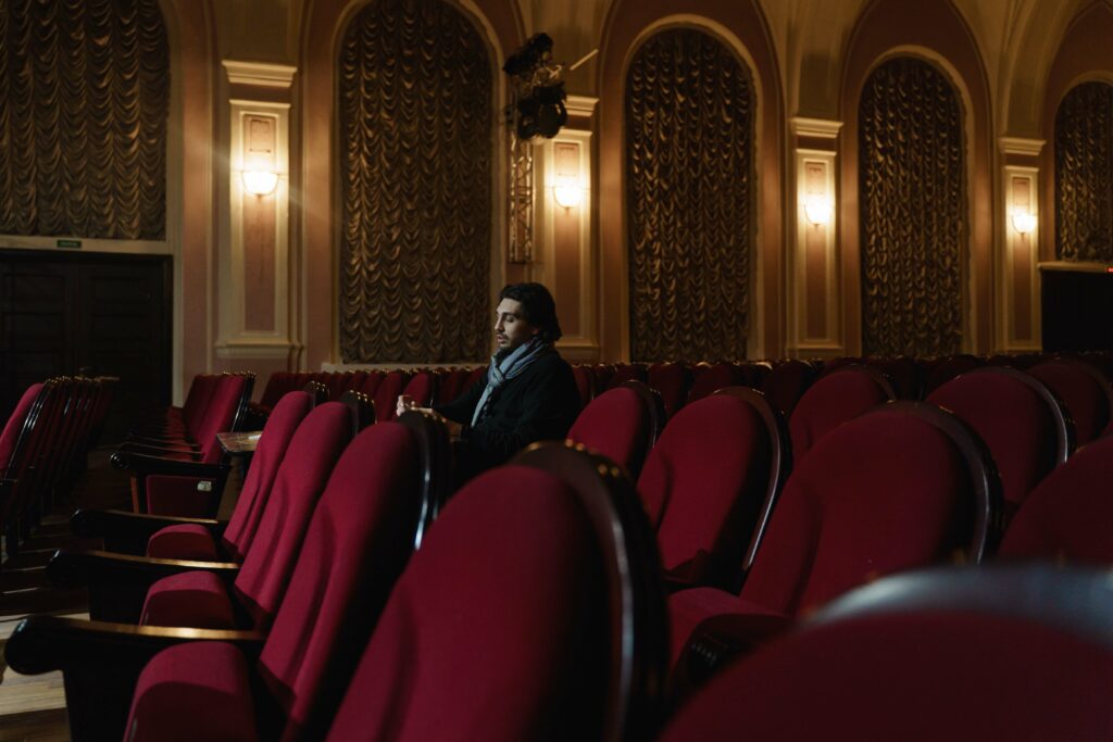man sitting in a theater alone
