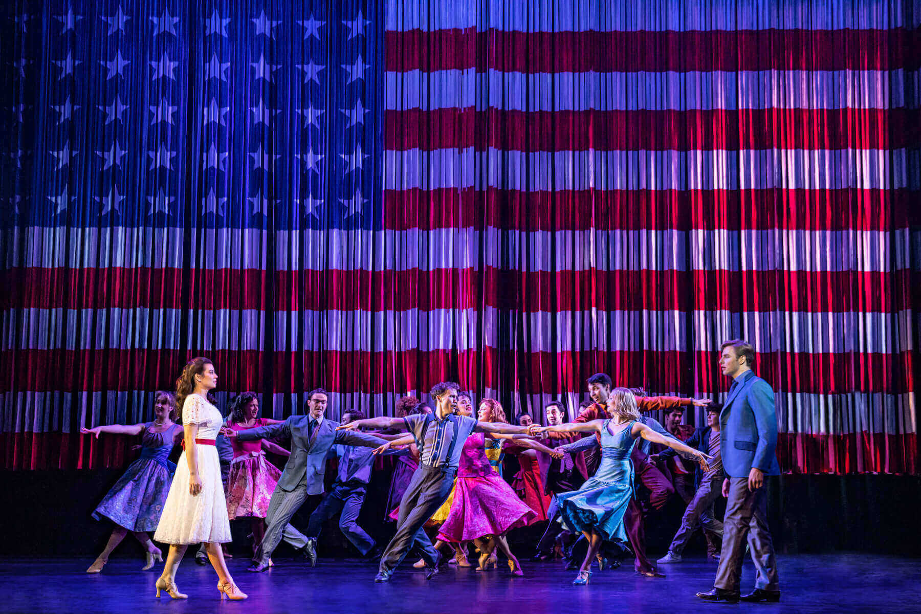 Dance scene with an American flag in the background